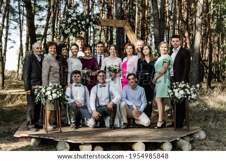 a large family of several generations gathered all together. international group of Family portrait at wedding.parents of a large family. father and mother. Aunt and uncle. brother and sister. husband