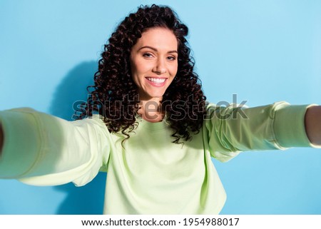 Portrait of pretty curly hairstyle positive girl make selfie toothy smile isolated on blue color background