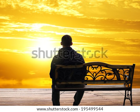 The lonely man sits on a decline.Creative Outdoor Photo.