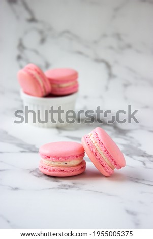 Homemade strawberry macaroons on white isolate background. French dessert.