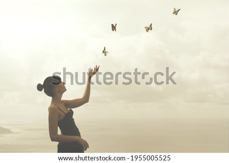 woman gently touches free flying butterflies Royalty-Free Stock Photo #1955005525
