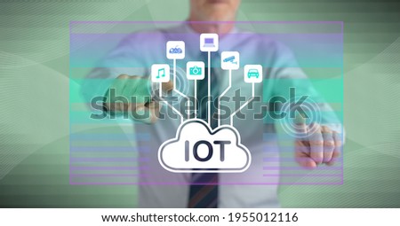 Man touching an iot concept on a touch screen with his fingers