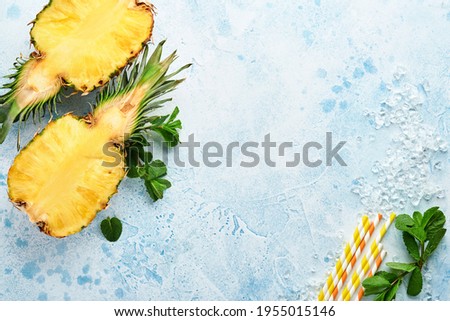 Sliced ripe pineapple on light blue stone background. Tropical fruits. Top view. Free space for text. Mock up.