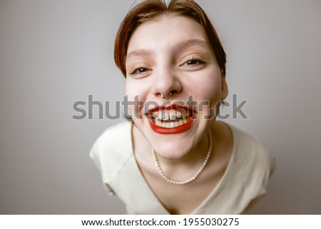 Cartoon portrait of a cheerful laughing girl with a big head on a light background