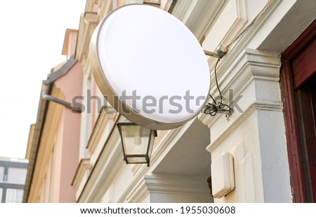 Round sign as a mock-up template on old building for advertising or logo design