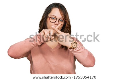 Young plus size woman wearing casual clothes and glasses rejection expression crossing fingers doing negative sign 