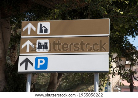 road sign with various indications of the city attractions