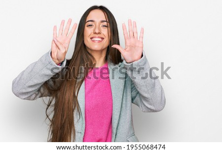 Young hispanic girl wearing business clothes showing and pointing up with fingers number nine while smiling confident and happy. 