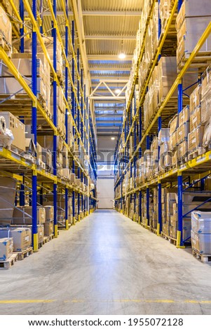 Interior of a modern warehouse storage with rows and goods boxes on high shelves Royalty-Free Stock Photo #1955072128