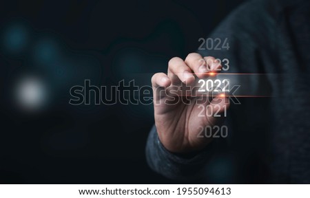 Businessman holding infographic  2022 year,Preparation Merry Christmas and happy new year concept.
