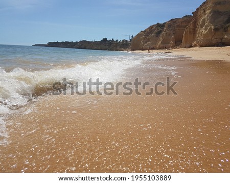foamy waves at the beach shore, photo taken in Portugal 