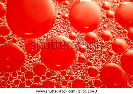 Abstract red looking oil and water bubbles of various sizes
