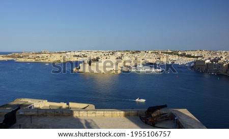 Panoramic view of Saint Angelo fort in the rays of sunset from Valletta fortress viewpoint. Birgu. Valletta. Malta.