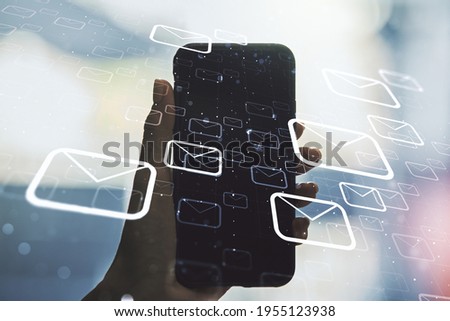 Creative concept of postal envelopes illustration and hand with phone on background. Email and communications concept. Multiexposure