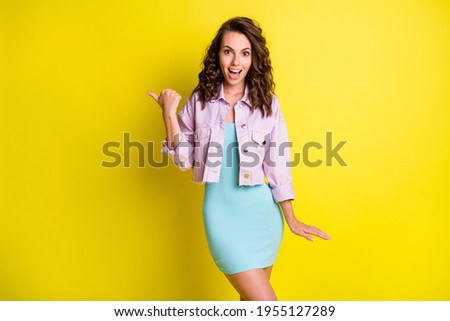 Photo of happy lovely charming excited amazed girl point finger copyspace advertise isolated on yellow color background