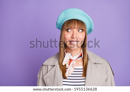 Photo of funny tricky lady bite lip look up empty space wear blue beret scarf coat isolated violet color background