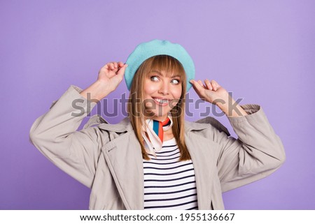 Photo of cute curious girl look empty space toothy smile wear blue beret coat isolated violet color background
