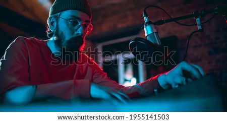 Artist. Close-up of musician performing in neon. Concept of advertising, hobby, music, festival, entertainment. Person improvising inspired. Flyer. Colorful modern, trendy neon lighted, artwork. Royalty-Free Stock Photo #1955141503