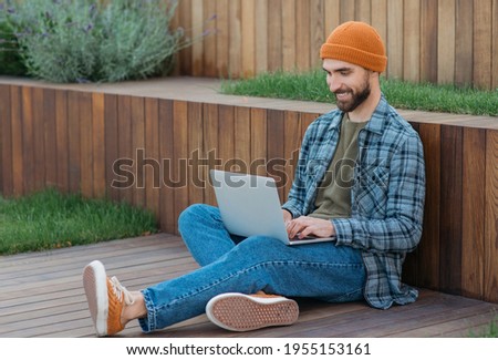 Young smiling programmer develop software , working freelance project from home. Handsome bearded man using laptop computer shopping online, watching videos. Happy student studying, distance learning 