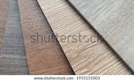 close up spc (stone composite) vinyl tile samples swatch containing multi color of chestnut and oak wooden texture surface. macro interior wooden flooring material. Royalty-Free Stock Photo #1955155003