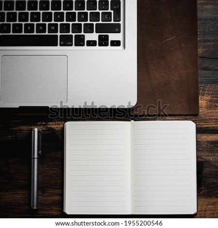 notebook and pen on the wooden desk
