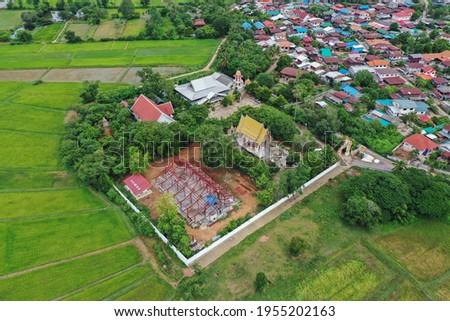 Top view with drone, countryside village with rice fields of Choraka District, Chaya-hum province, Thailand