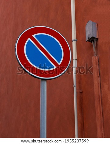 No parking sign on red wall in nice composition