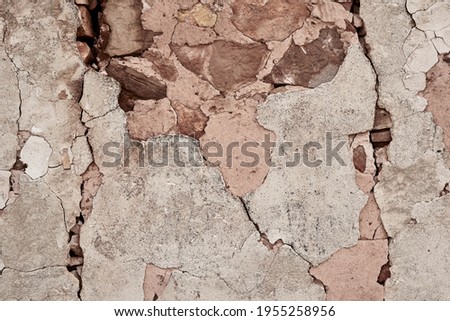 Old traditional limewashed stone wall with peeling plaster, white rustic background