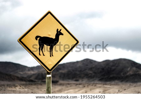 wild fauna warning sign on the middle of the atacama desert with bokeh