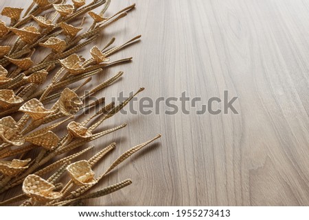 Flowers are made of straw on a wooden background. Copy space 