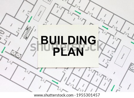 Business card with text Building Plan on a construction drawing. Concept photo