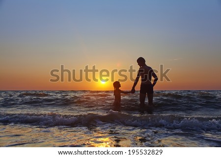 father and daughter admire the sunset on the sea. vacation at the seaside