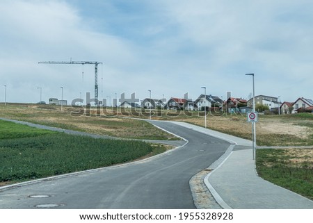 Road construction and new development of a residential area on the outskirts of the village Royalty-Free Stock Photo #1955328928