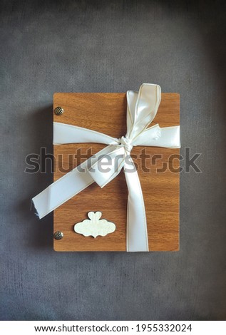 wooden gift box with name attached to a white ribbon
