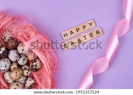Top view pink nest of quail eggs and pink ribbon on purple background.