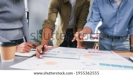Young Asian business financial team work together in project brainstorm meeting. Cooperate teamwork, strategy planning, small business startup company, or office coworker collaborate concept Royalty-Free Stock Photo #1955362555