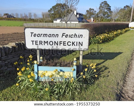 Roadside sign for Termonfeckin village or Tearmann Feichin in the Irish language, in County Louth, Ireland.  Royalty-Free Stock Photo #1955373250