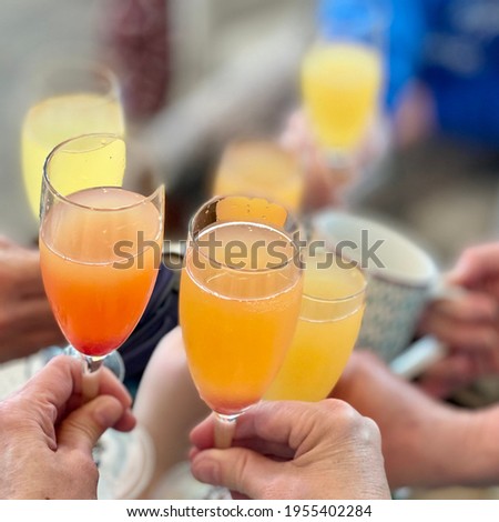 Mimosas with friends on the beach. So much fun and so much laughter! Can’t wait to go back! Delicious! Royalty-Free Stock Photo #1955402284