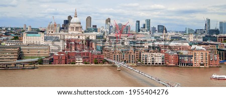 London, panoramic aerial view over Thames river with Millennium bridge, St. Paul and London skyline. Toned image.