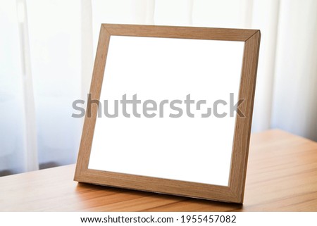 Blank Photo Frame on a wooden table mockup and template Photo Frame for text message or media and content, interior, Art Canvas