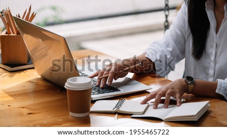 Cropped photo of woman writing making list taking notes in notepad working or learning on laptop indoors- educational course or training, seminar, education online concept.