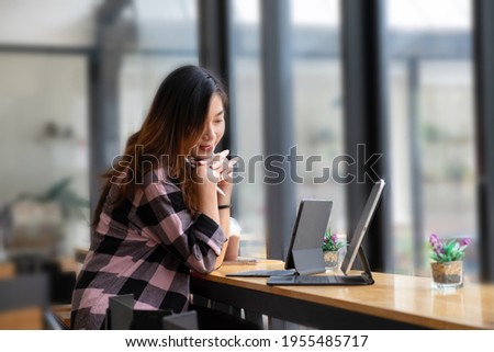 Businesswoman focusing on her assignment with laptop on wooden d