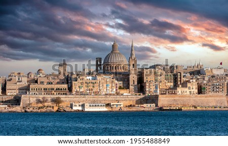Valletta, Malta, Skyline in the afternoon with the dome of the Carmelite Church and the tower of St Paul`s, cloudy sky background