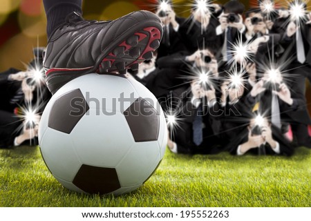 many photographer taking winner soccer player feet on field