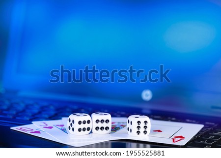 Online gaming platform, casino and gambling business. Cards, dice on laptop keyboard