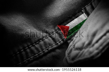 Tag on dark clothing in the form of the flag of the Palestine