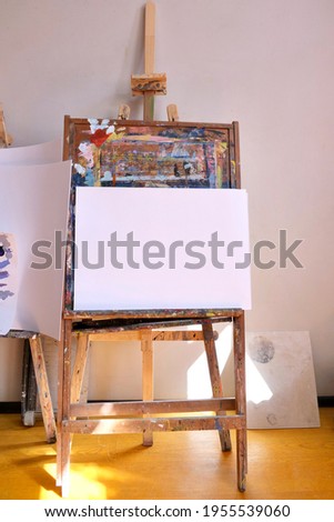 A large easel with a white sheet of paper for drawing in the sun. Art concept. 