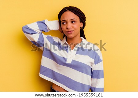 Young african american woman isolated on yellow background tired and very sleepy keeping hand on head.