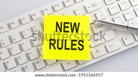 text NEW RULES on keyboard on the white background