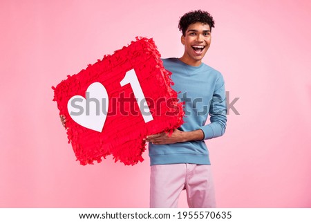 Photo of young excited afro man happy positive smile hold paper pinata like icon social blogging isolated over pastel color background